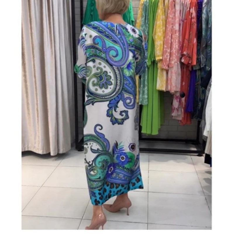Elegant lang kjole med rund hals og blomsterprint